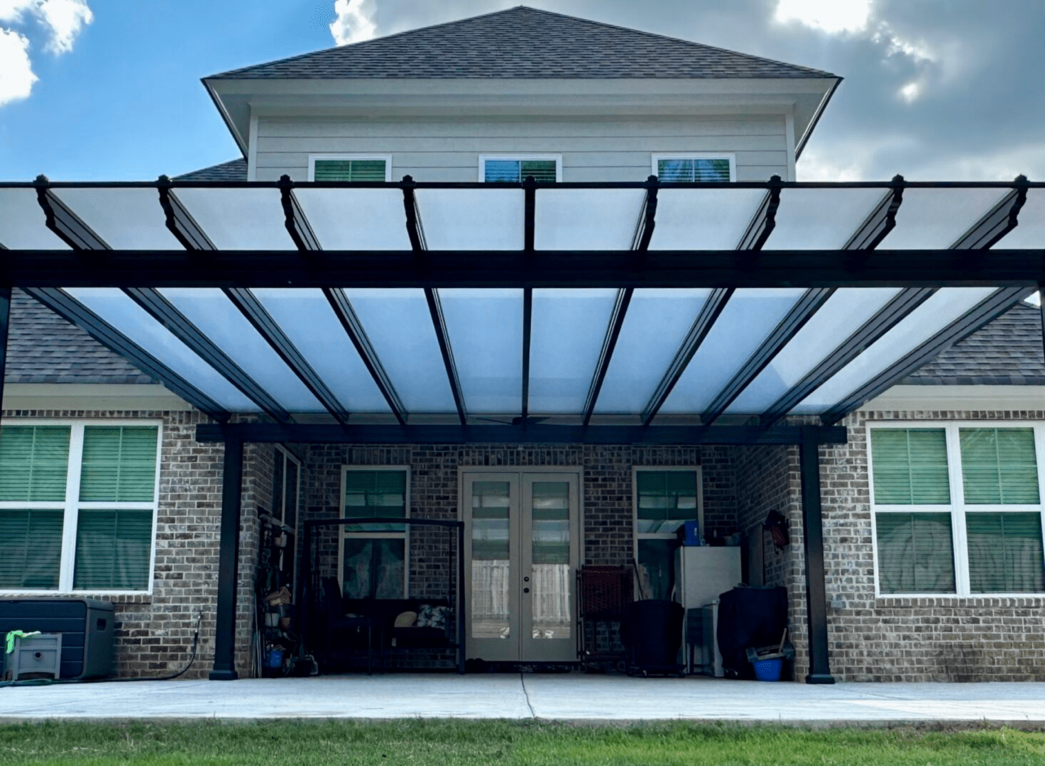 A house with a large patio cover over the entrance.