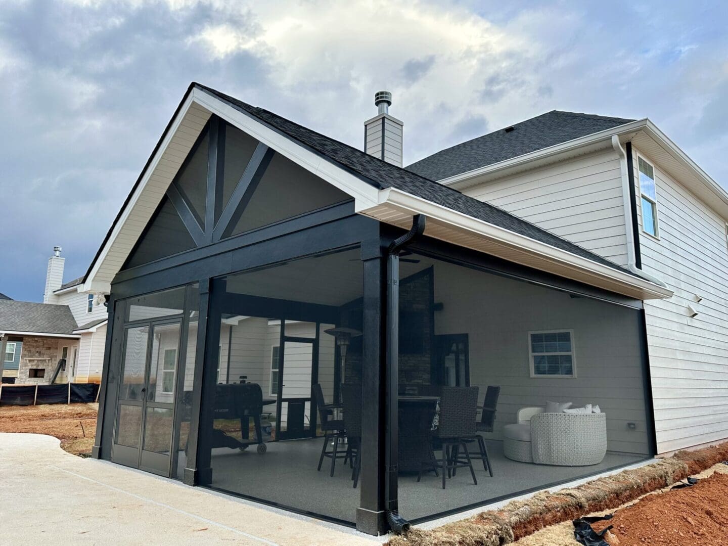 Modern home with black screened-in patio