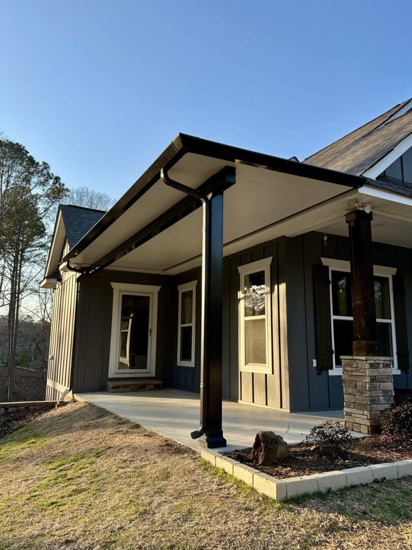 Modern farmhouse covered porch with black columns