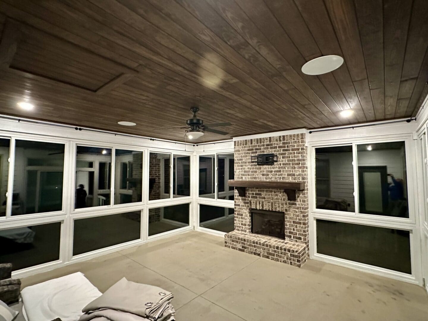 Enclosed patio with brick fireplace and wooden ceiling