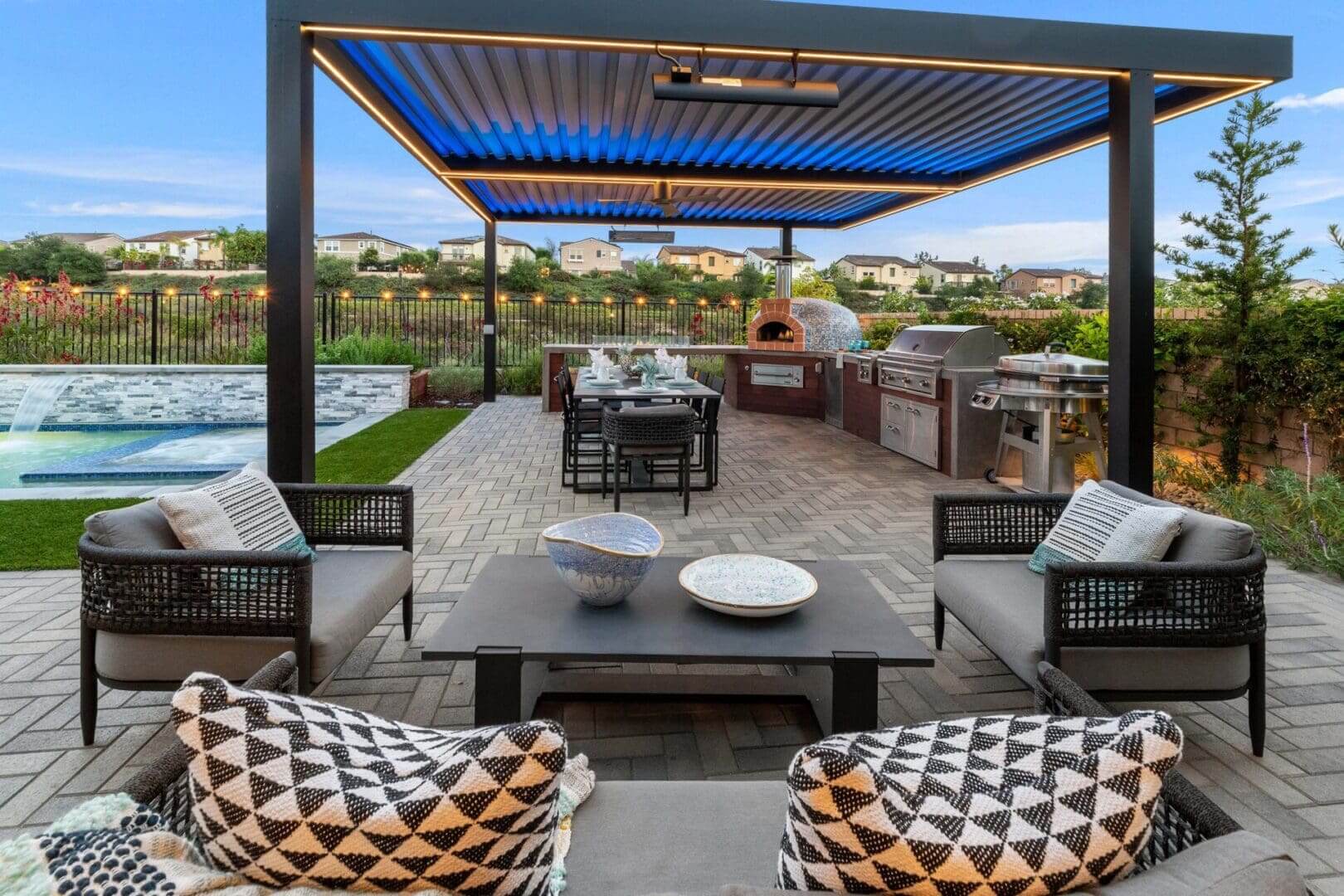 Stylish backyard pergola with outdoor kitchen and pool
