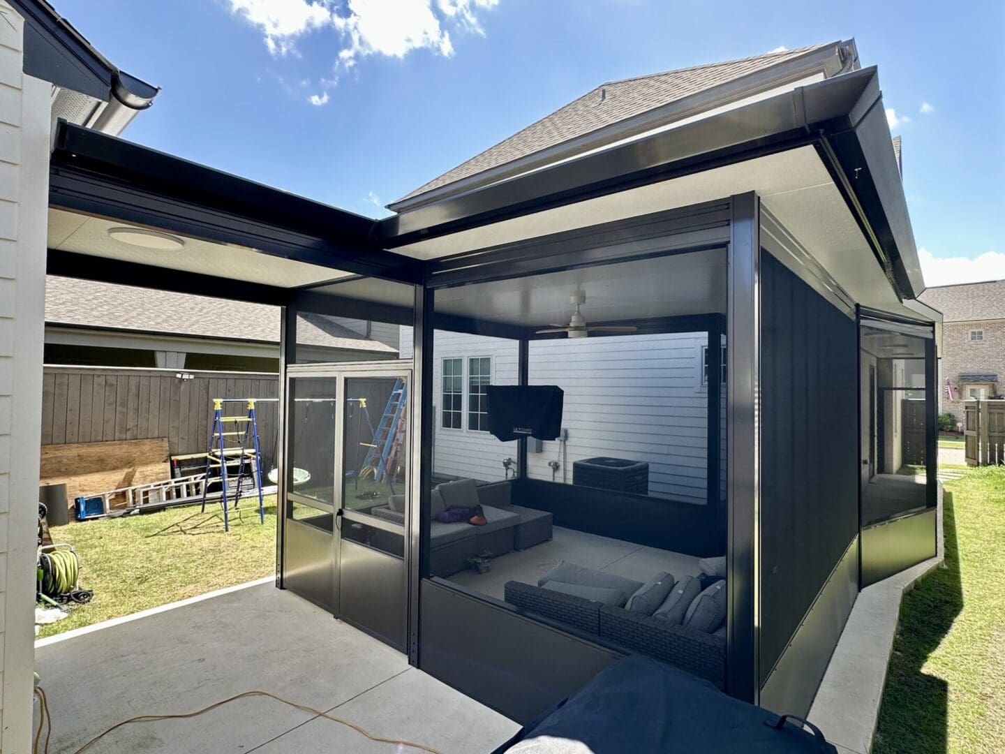 Black framed screened porch with outdoor seating