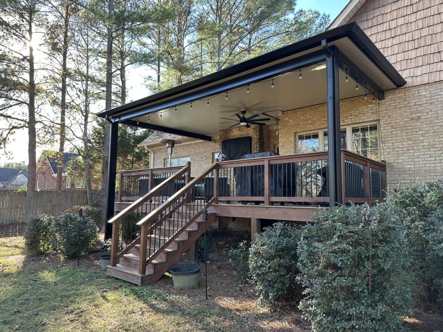 Raised covered backyard deck with ceiling fan