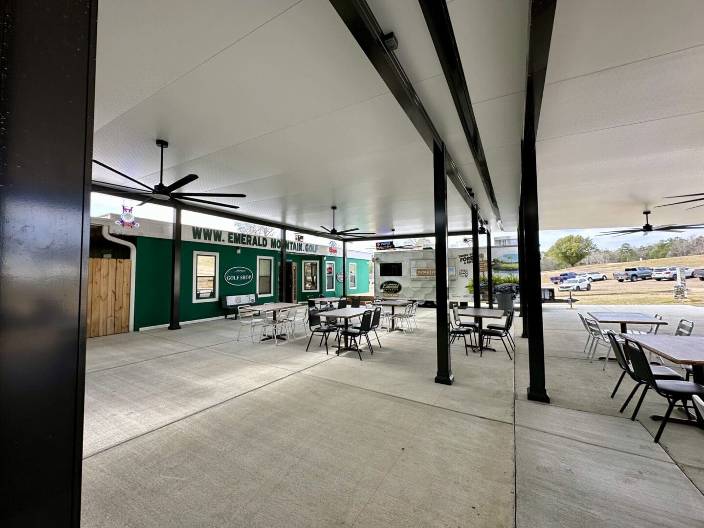 Covered outdoor dining area with ceiling fans