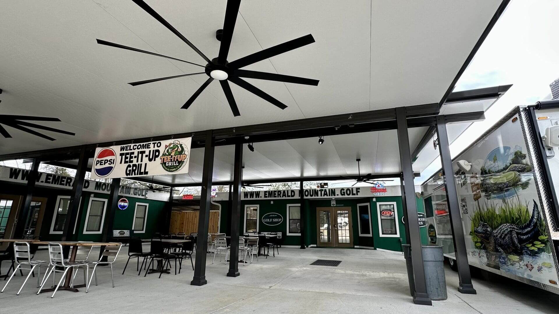 Emerald Mountain Golf clubhouse patio with fans