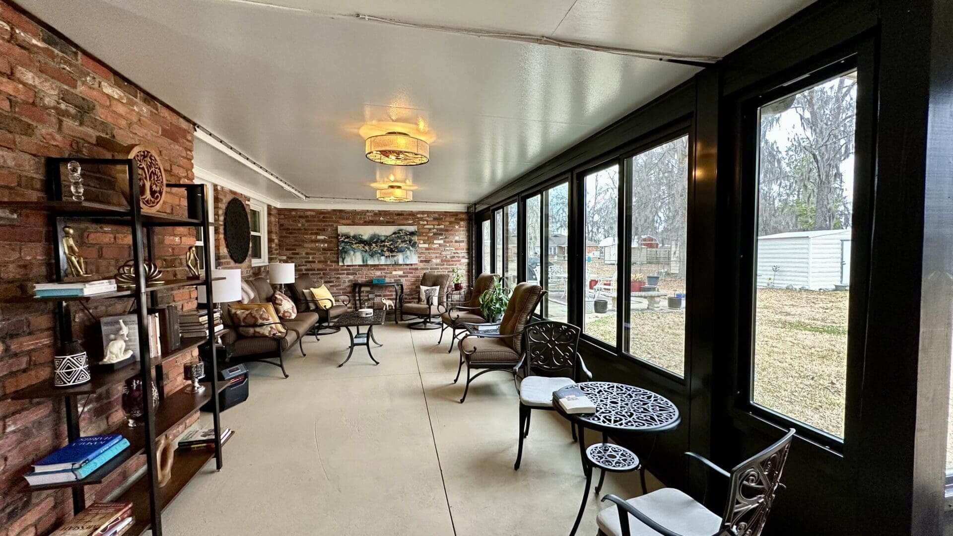 Cozy enclosed sunroom with seating and windows