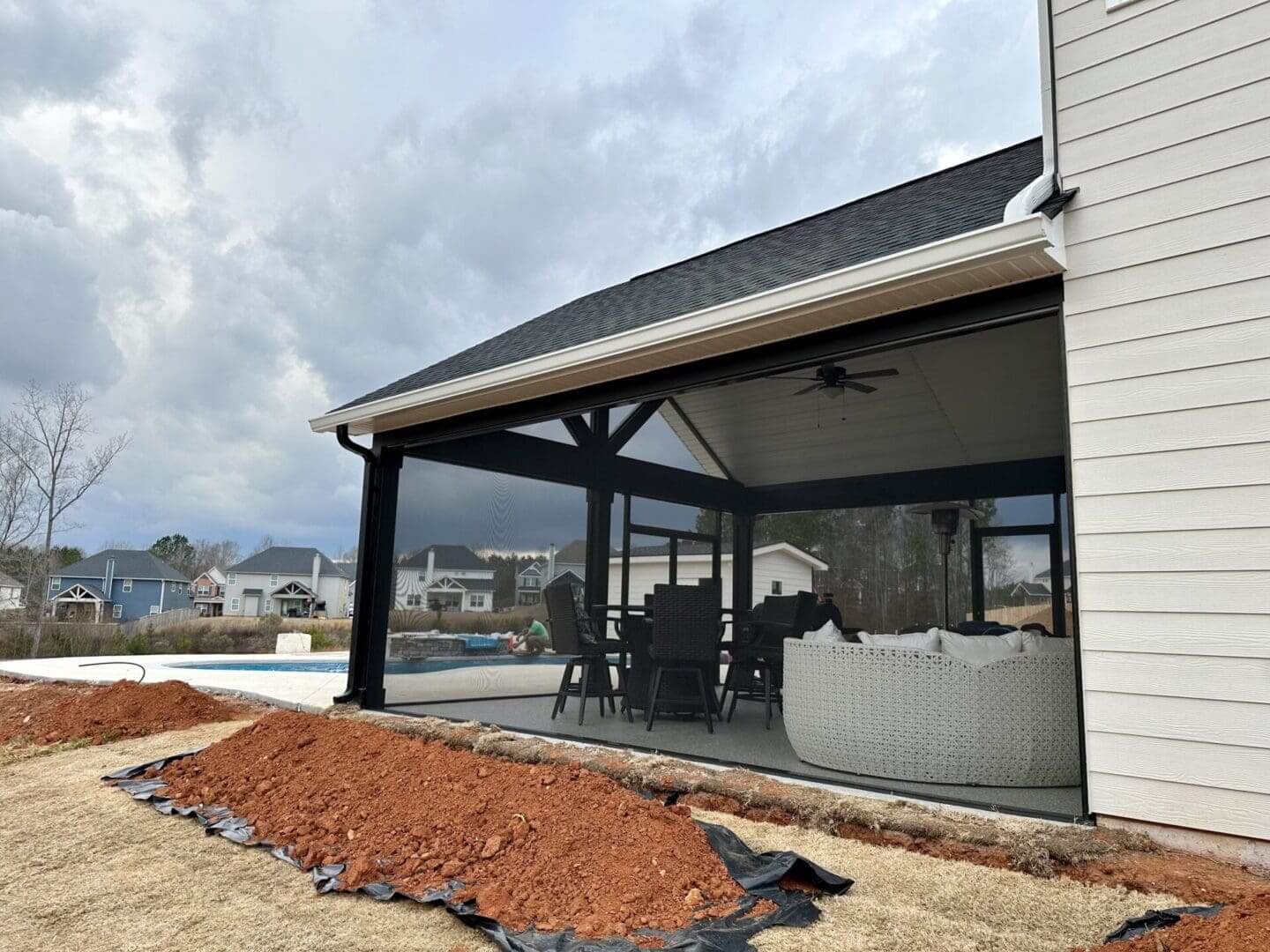 Covered screened patio with outdoor dining furniture