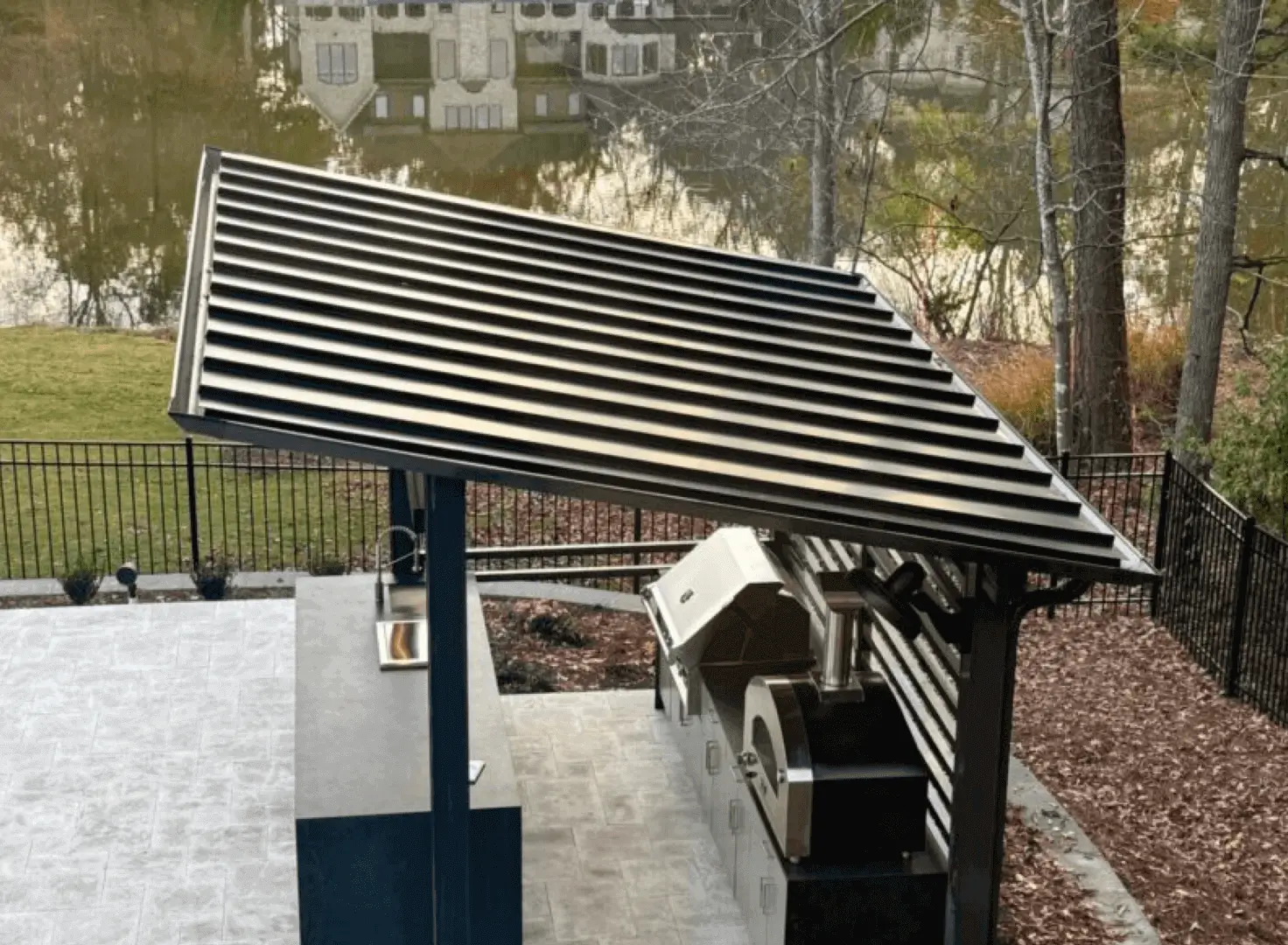 Modern louvered pergola sheltering outdoor grill